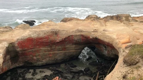 Couple down at Devils Punchbowl Natural Area on a foggy day, Oregon - 4K Stock Footage 238490656