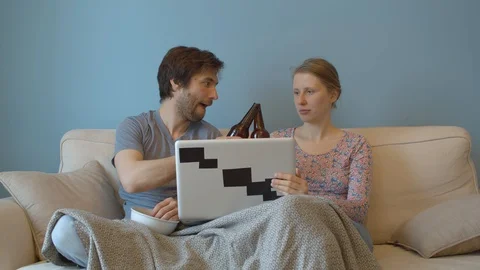 Couple drinking beer on the sofa Stock Footage 129233125