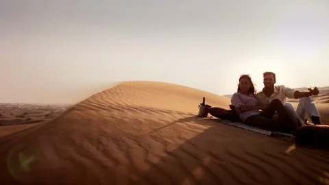 Couple drinking champagne on desert. Stock Footage 119379819