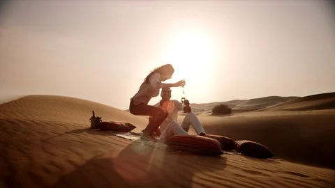 Couple drinking champagne on desert. Stock Footage 119386925