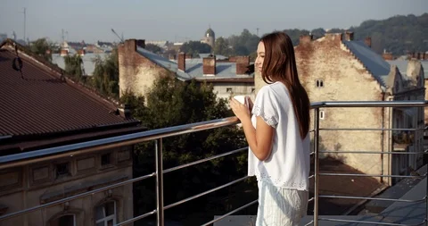 Couple Drinking Coffee and Embracing on Balcony 動画素材 116620705