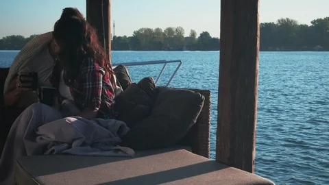 Couple drinking coffee and having fun by the river Stock Footage 99977808