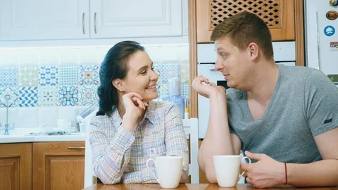 Couple is drinking coffee, talking and smiling Stock Footage 106347800