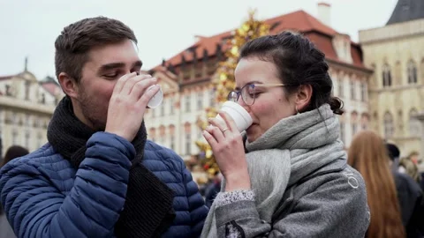 Couple drinking hot wine and kissing, Christmas tree on Prague Old Town Stock Footage