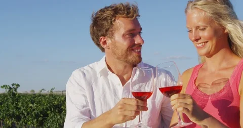 Couple drinking red rose wine toasting at vineyard - romantic date Stock Footage 86340405