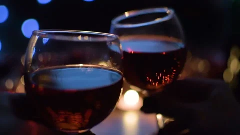 A couple drinking red wine. Light garlands in the background. Vídeos de archivo 97367082
