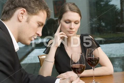 Couple drinking red wine looking unhappy Stock Photos