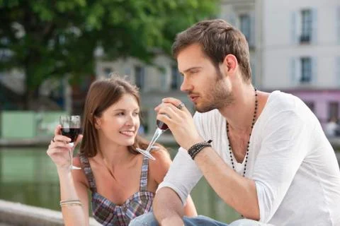 Couple drinking red wine, Paris, Ile-de-France, France Stock Photos