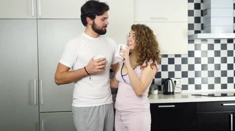 Couple drinking tea and chatting in the kitchen slow motion Stock Footage 59190021
