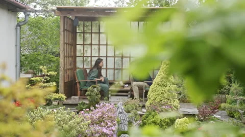 Couple drinking tea in gazebo Stock Footage 202100909