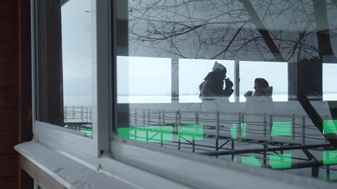 A couple is drinking tea. View through the window Stock Footage 129102117