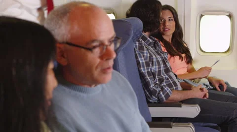 Couple drinking water bottle on plane Video stock 67344855