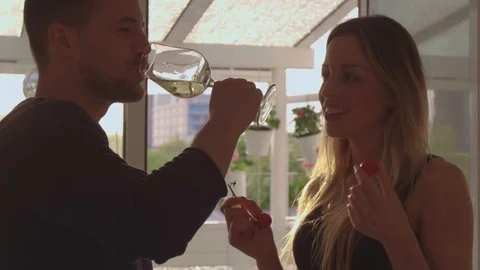 Couple drinking wine and eating cherries Stock Footage 111256366