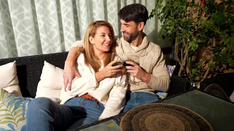 Couple drinking wine and relaxing on patio Stock Footage 303554607