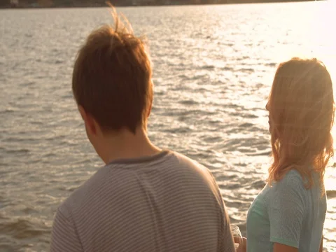 A couple drinking wine and walking down the beach at sunset Video stock 80599375