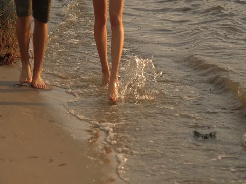 A couple drinking wine and walking down the beach at sunset Stock Footage 80599376