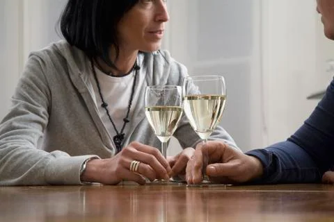 A couple drinking wine at a dining table Stock Photos