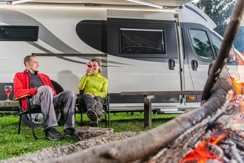Couple Drinking Wine in Front of Their RV Camper Van Foto stock