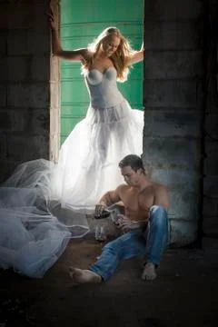 Couple drinking wine in a run down building. Stock Photos