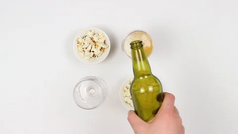 A couple drinks beer and eats popcorn. Woman and a man. Top view. Fast shooting. Stock Footage 88824235