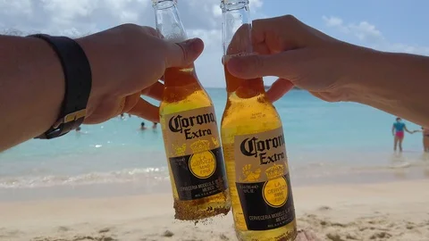 Couple Drinks Corona on beach in St Kitts Stock Footage 104786522