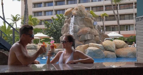 Couple Drinks Tropical Drinks Poolside at Pool Bar, Beach Resort Stock Footage 103220557