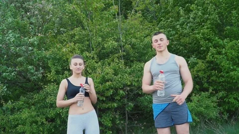 Couple drinks water from a bottle Stock Footage 78050486