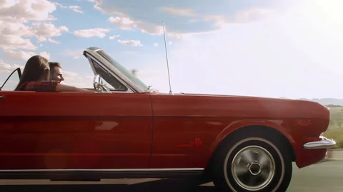Couple driving classic cherry red convertible, cabriolet car, steadicam shot. Vídeo Stock 199632068