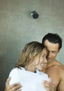 Couple drying off in shower Stock Photos