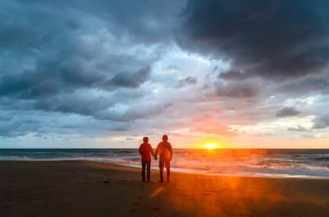 A couple during the sunset at the beach Stock Photos