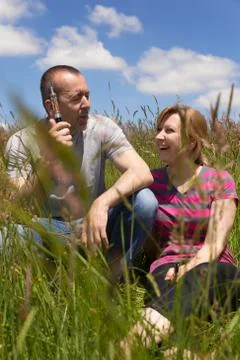 Couple with e-cigarette in a meadow Stock Photos
