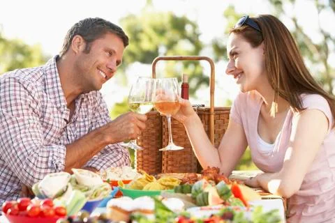 Couple Eating An Al Fresco Meal, Toasting With Wineglasses Stock Photos