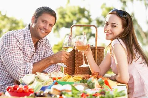 Couple Eating An Al Fresco Meal, Toasting With Wineglasses Stock Photos