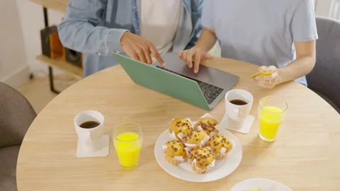 Couple eating breakfast while shopping online with credit card Stock Footage 238026557