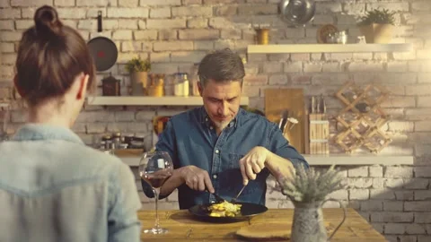 Couple eating in kitchen at home drinking wine Stock Footage 143113809
