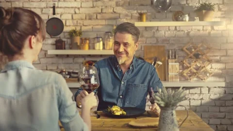Couple eating in kitchen at home drinking wine Видео 155122266