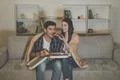 The couple eating a pizza and watch a movie on the sofa Photo