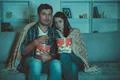 The couple eating popcorn and watch a horror movie on the sofa Photo
