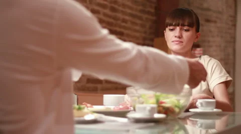 Couple eats meal together, focus on woman Stock Footage 6130607