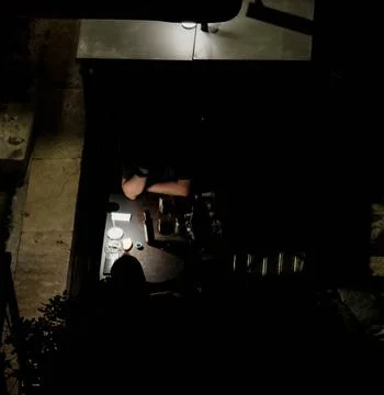 Couple eats at restaurant romantically in dim light Photos