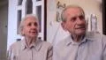 Couple of elderly people seeing a film about past times HD Footage