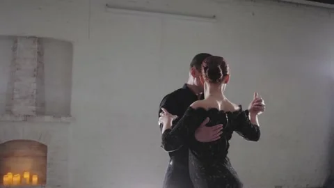Couple in elegant clothes dances Argentinian tango at light Stock Footage 135954833