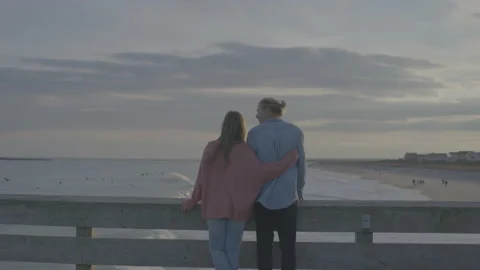Couple Embrace On Dock At Beach Stock Footage 208784919