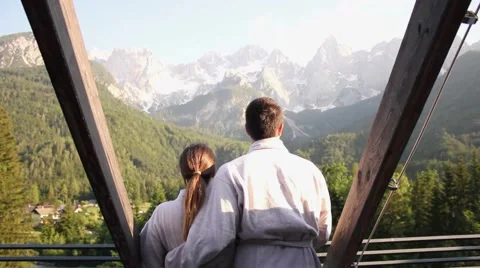 Couple embraced in spa looking at mountain panorama Video stock 61162846