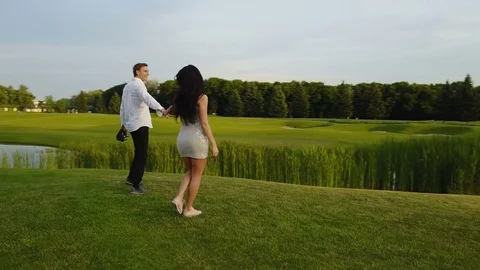 Couple Embracing And Kissing Outdoors, Shooting From Drone Circling Above Stock Footage
