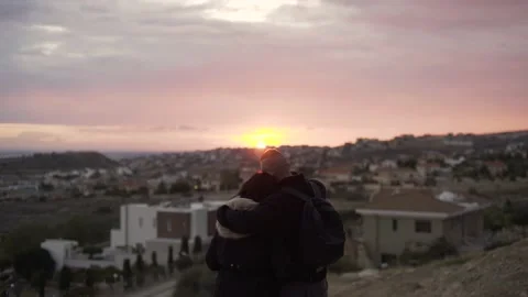 Couple embracing and looking at panoramic city view at sunset Stock Footage 149392546