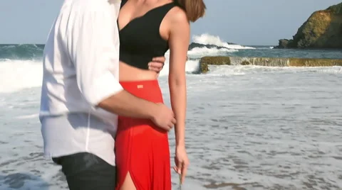 Couple embracing on the beach. Man spins girl Stock Footage 62216477
