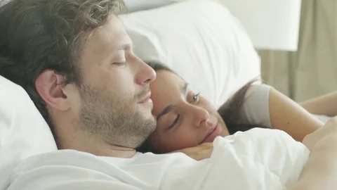 Couple embracing in bed Stock Footage 75176699