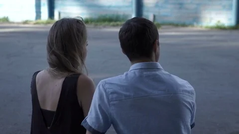 Couple embracing on bench Stock Footage 79499790