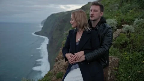 Couple embracing on cliff overlooking ocean Stock Footage 308365237